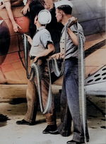 Ordnancemen loading belted cartridges into SBD-3 at Naval Air Station Norfolk, Virginia, United States, Sep 1942