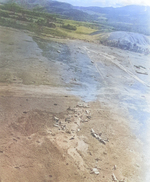 Bomb Damage Assessment photo of destroyed Ki-48 bombers at a Japanese airstrip in northern New Guinea, 1942-1943, photo 2 of 2; note open parachutes in upper center (bombs or supplies?)