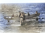 US Navy pilot Lt. (jg) John Burns, Radioman Aubrey J. Gill, and their rescued passengers awaiting rescue aboard OS2U Kingfisher aircraft, off Truk, Caroline Islands, 1 May 1944, photo 2 of 2