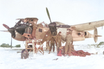 Armorers and mechanics of US 9th Air Force servicing a P-38 Lightning aircraft in the field, 1944; note external engine warmer