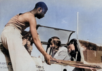 US Army African-American aviators crew chief Staff Sergeant Alfred D. Norris and pilot Captain William T. Mattison prepared for a mission with a P-51 Mustang fighter, Italy, circa Sep 1944