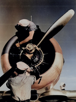 Mechanics check the engine of a SNJ at Kingsville Field, Corpus Christi, Texas, Nov 1942