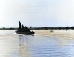 Destroyer USS Shaw underway in Pearl Harbor with a temporary stub bow, 8 Feb 1942; note SOC floatplane taxiing nearby