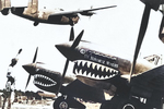 B-24 Liberator bomber taking off from an advance air field in Kunming, China, circa 1943; note P-40 Warhawk fighters in foreground