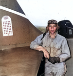 Machinist Donald Runyon posing at the tail of his Wildcat during the Guadalcanal campaign, 10 Sep 1942