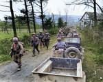 Men of Company C, 1st Battalion, 18th Infantry Regiment, US 1st Infantry Division marching toward Frauwüllesheim, Germany, after crossing the Roer River, 28 Feb 1945