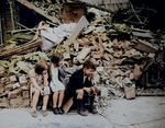 Homeless children in front of their wrecked home, eastern London suburb, Sep 1940