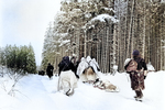 Troops of US 82nd Airborne Division marching, near Herresbach, Belgium, 28 Jan 1945; note heavily loaded ammunition sled