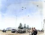 Troops of US 101st Airborne Division watching C-47 Skytrain aircraft delivering supplies to their unit, Bastogne, Belgium, 26 Dec 1944