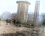 Men of US 101st Airborne Division walking past dead comrades, killed during Christmas Eve bombing of Bastogne, Belgium, 25 Dec 1944