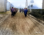 Men of US 28th Infantry Division marching down a street in Bastogne, Belgium, 20 Dec 1944