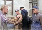 Russian former prisoner liberated by US 3rd Armored Division pointing out former Nazi guard who brutally beat prisoners, possibly at Mittelbau-Dora Concentration Camp, Nordhausen, Germany, 14 May 1945