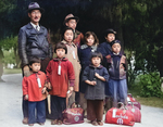 Members of the Mochida family awaiting evacuation bus to internment camp, California, United States, 8 May 1942