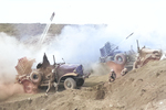 US Marine rocket-launching trucks in action on Iwo Jima, Japan, 28 Feb 1945; note Mk 7 rocket launcher firing 4.5-inch beach barrage rockets