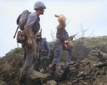 A US Marine threw a grenade at enemy sheltered in a northern Iwo Jima cave, Japan, Feb-Mar 1945