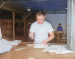 Chief Postal Orderly Masaki Hironoka at work at the post office at Jerome War Relocation Center, Arkansas, United States, 20 Nov 1942