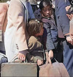 Japanese-American children awaiting for a bus that would take them to an Assembly Center, Byron, California, United States, 2 May 1942