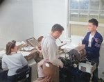 Eunice Yakota, Kiyomi Nakamura, Tsugio Makagama, and Ray Kawamoto working at the office of the newspaper Jerome Communique, Jerome War Relocation Center, Arkansas, United States, 18 Nov 1942