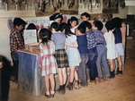 Fourth grade Japanese-American children at a cooperative store stand selling valentines, Jerome War Relocation Center, Arkansas, United States, Feb 1944, photo 1 of 3