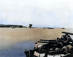 40mm gun crew of an unidentified American cruiser watched as lighter vessels shelled a Japanese storage dump (note smoke in center), Asan Beachhead, Guam, Mariana Islands, 21 Jul 1944