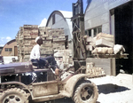 US Navy Seamen 1st Class M. D. Shore operating a forklift truck at a Navy supply depot at Guam, Mariana Islands, 8 Jun 1945