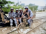 African-American men of the US Marine Corps Third Ammunitions Company at Saipan, Mariana Islands, Jun 1944; Pfc Boykin on bicycle; Pfcs Anthony, Shackelford, and Purdy watching