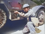 An ethnically Chinese soldier of the US Army posing with a Thompson sub-machinegun next to a halftrac armored car, Fort Knox, Kentucky, United States, Jun 1942