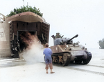 A French Army Sherman tank landed on a Normandy beach from LST-517, 2 Aug 1944