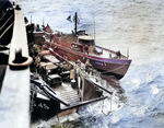 A LCT and an US Coast Guard-manned boat operating off Normandy, France, Jun 1944; note jeep vehicles onboard the LCT