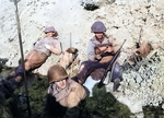 US Army Rangers resting near Pointe du Hoc, Normandy, France, inland from Omaha Beach, 6 Jun 1944; note soldier using finger to push cartriges into magazine of his M1 Carbine