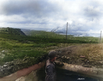 A US Army major looked over Cherbourg from one of the concrete pillboxes above the city, 26 Jun 1944