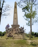 African-American US Marines and sailors resting at the base of a Japanese war memorial, Okinawa, Japan, 12 Apr 1945. On steps: Snowden, Martin. On monument: Walton, Ellenberg, Brown, Brawner.