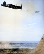 A Corsair fighter ripple firing its HVAR rockets at Japanese positions at Okinawa, Japan, Jun 1945