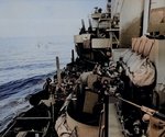 Gun crew of cruiser Phoenix tried to identify an aircraft above, off Mindoro, Philippine Islands, 15 Dec 1944