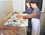 Lieutenant May Felts, chief dietician to the American delegation to the Potsdam Conference, inspecting the food being prepared, Germany, 16 Jul 1945