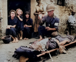 US Army Private First Class Harvey White administering plasma to wounded Private Roy Humphrey, Sicily, Italy, 9 Aug 1943