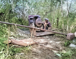 Man of 34th Construction Battalion working on water purification equipment, Solomon Islands, circa Aug 1945