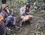 US Marine battalion commanding officer Lieutenant Colonel John Weber receiving a report from a company commander, Cape Gloucester, New Britain, Bismarck Archipelago, Jan 1944