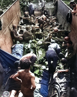 American casualties lying on stretchers aboard a landing craft, awaiting evacuation, Munda Point, New Georgia, Solomon Islands, 12 Jul 1943