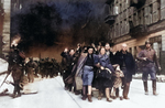 Yehudit Neyer (dark-haired woman), madam Neyer (center), Avraham Neyer (next to child), and the rest of the Neyer family leading a column of Jews being marched out of the Warsaw ghetto gate for deportation, Warsaw, Poland, Apr-May 1943, photo 1 of 2