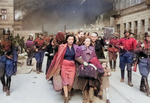 Yehudit Neyer (dark-haired woman), madam Neyer (center), Avraham Neyer (next to child), and the rest of the Neyer family leading a column of Jews being marched out of the Warsaw ghetto gate for deportation, Warsaw, Poland, Apr-May 1943, photo 2 of 2