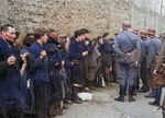 SS personnel guarding rounded-up Jews in the Warsaw ghetto, Poland, Apr-May 1943