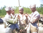 African-American US Army 2nd lts. Henry Harris, Frank Frederick Doughton, Elmer B. Kountze, and Rogers H. Beardon pinning on their new brass rank insignias, Ft. Benning, Georgia, US, 29 May 1942