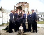 US Coast Guardsmen Joseph Andy, Casiano Aquino, Vincent G. Igoe, George Trigony, Carlton Lee, and Daniel Riley using a payphone Scotland, date unknown; note the mixing of ethnicities