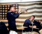 African-American US Navy Construction Battalion Coxswain Thomas J. Lindsey (trumpeter) and Seaman 1st Class Edward A. Grant (drummer) playing in England, United Kingdom, 14 Dec 1944