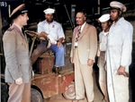 Lester Granger chatting with African-American US Navy S1/c Rofes Herring, S2/c Walter Calvert, and civilian Nollie H. Million, 20 Jun 1945; the officer was identified as Lt Roper