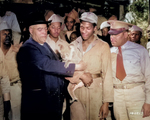 Bishop John Andrew Gregg of African Methodist Church in North Central United States playing with a koala bear while African-American US Army soldiers looked on, Australia, 21 Jul 1943