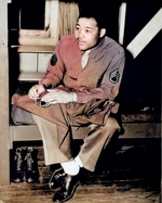 African-American boxing champion and US Army Technical Sergeant Joe Louis sewing his rank patch onto his uniform, 10 Apr 1945