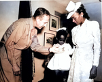 US Army BrigGen Robert N. Young presenting the Silver Star medal to the widow and daughter of African-American 1st Lt John W. Madison of 92nd Division, who was killed in Italy, date unknown