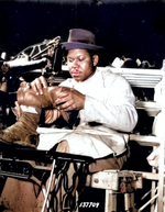 African-American Howard Wilson making a pair of paratrooper boots at a sewing machine in the C & E Shoe Shop at Fort Benning, Georgia, United States, Jul 1942